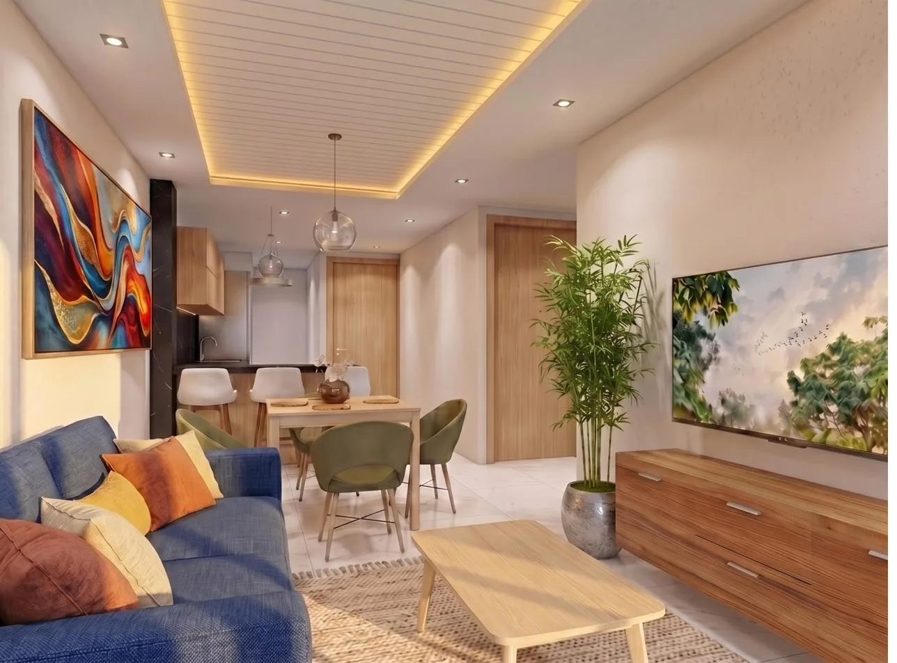 Sala con sofá azul, comedor y mueble de televisión